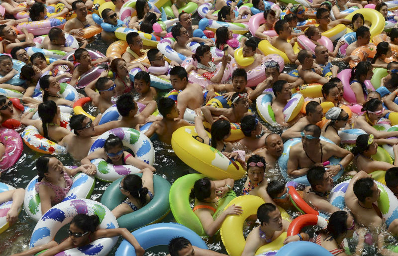 Visitors crowd an artificial wave swimming pool at a tourist resort to escape the summer heat in Daying county of Suining, Sichuan province, China, July 11, 2015. u00e2u20acu201d Reuters pic