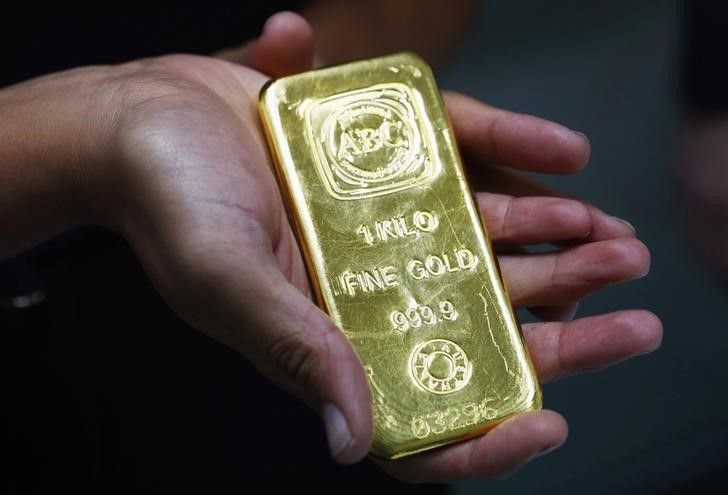 A woman holds a one-kilogramme gold bar at the headquarters of the Australian Bullion Company (ABC) in Sydney April 19, 2013. u00e2u20acu201d Reuters pic