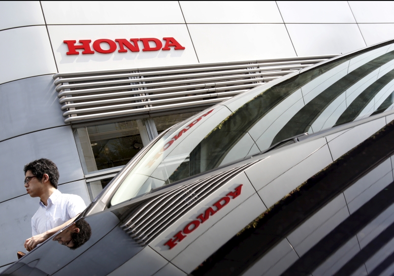 A man walks past a Honda Motor Co's car displayed outside a showroom at the company's headquarters in Tokyo, Japan, July 31, 2015. u00e2u20acu201d Reuters pic