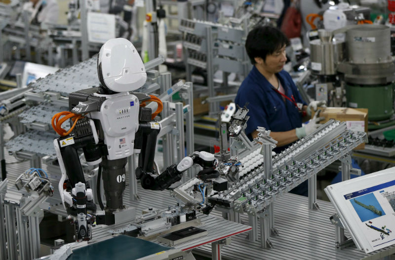 A humanoid robot works side by side with employees in the assembly line at a factory of Glory Ltd, a manufacturer of automatic change dispensers, in Kazo, north of Tokyo, Japan, July 1, 2015. u00e2u20acu201d Reuters pic