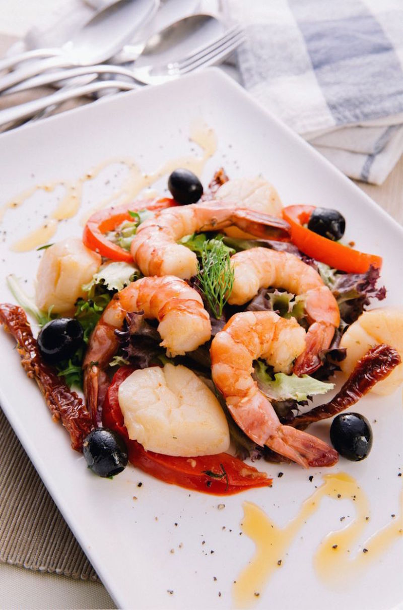 Capri’s regular menu also boasts some less obvious choices, such as is this dish of herb-seasoned prawns and scallops served with a sundried tomato and black olive sauce. — TODAY pic