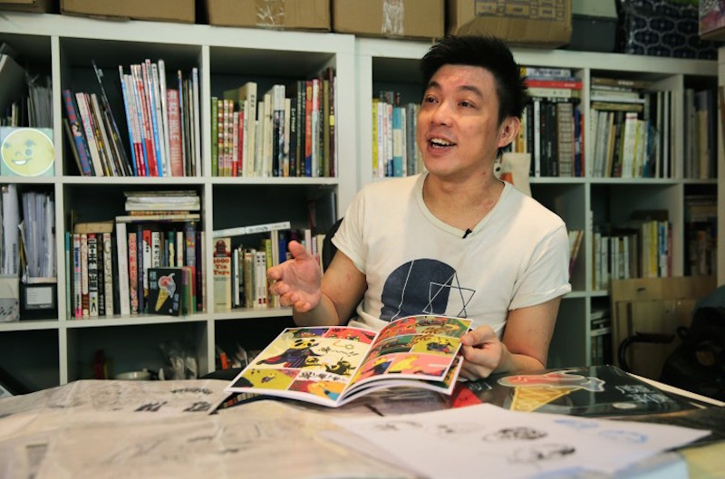 Local artist Kongkee explains his Blur comic book in his studio in Hong Kong. — AFP pic