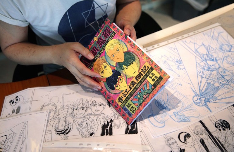 Local artist Kongkee with draft sketches and his Blur comic in his studio in Hong Kong. u00e2u20acu201d AFP pic