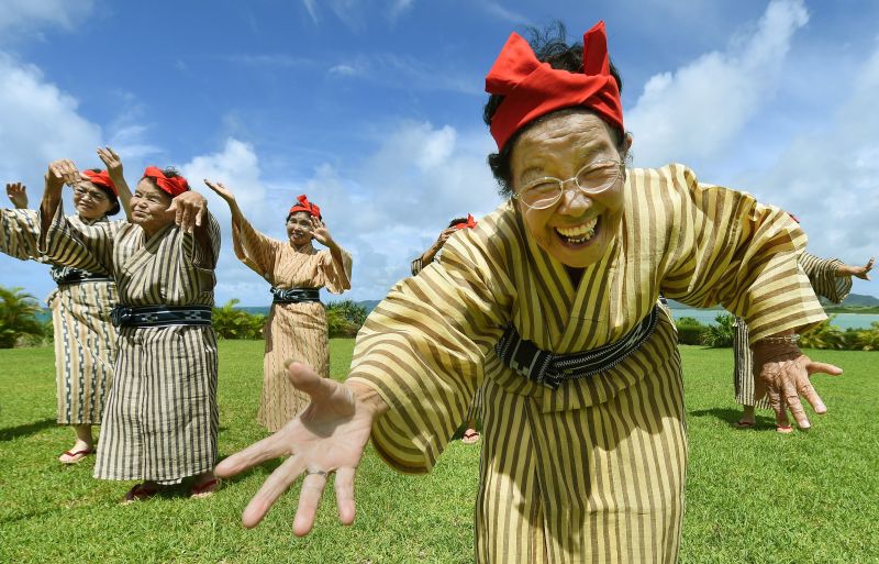 Tomi Menaka, 92, fronts the 33-strong geriatric pop idols from Kohama Island in Okinawa wearing traditional local costumes, performing at a herb garden on Kohama Island, Okinawa Prefecture June 22, 2015. AFP