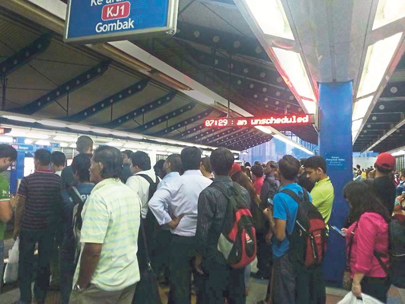 Passengers waiting to board an LRT train. u00e2u20acu2022 Malay Mail pic