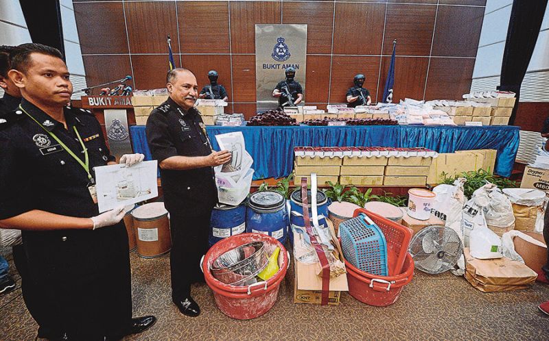 Datuk Seri Mohd Mohktar Mohd Shariff shows the drugs and paraphernalia seized from the syndicate. u00e2u20acu201dBernama pic