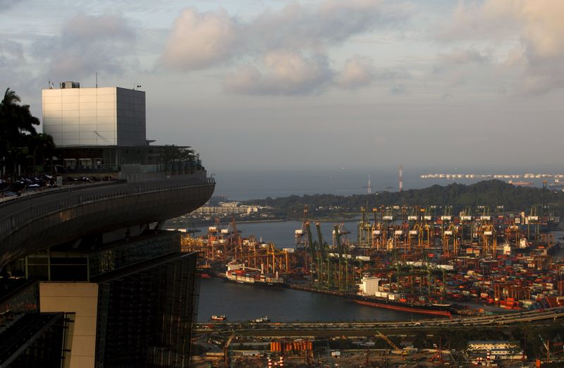 People swim in the infinity pool of the Marina Bay Sands hotel, next to PSA International's Tanjong Pagar Container Terminal in Singapore July 22, 2015. u00e2u20acu201d Reuters pic