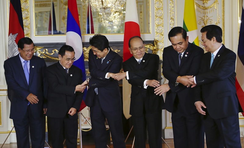 (From left) Hun Sen, Thongsing Thammavong, Shinzo Abe, Thein Sein, Prayuth Chan-ocha and Nguyen Tan Dung, join hands for a group photo, prior to the 7th Mekong-Japan Summit meeting at the Akasaka State Guest House in Tokyo, July 4, 2015. u00e2u20acu201d Reuters pic