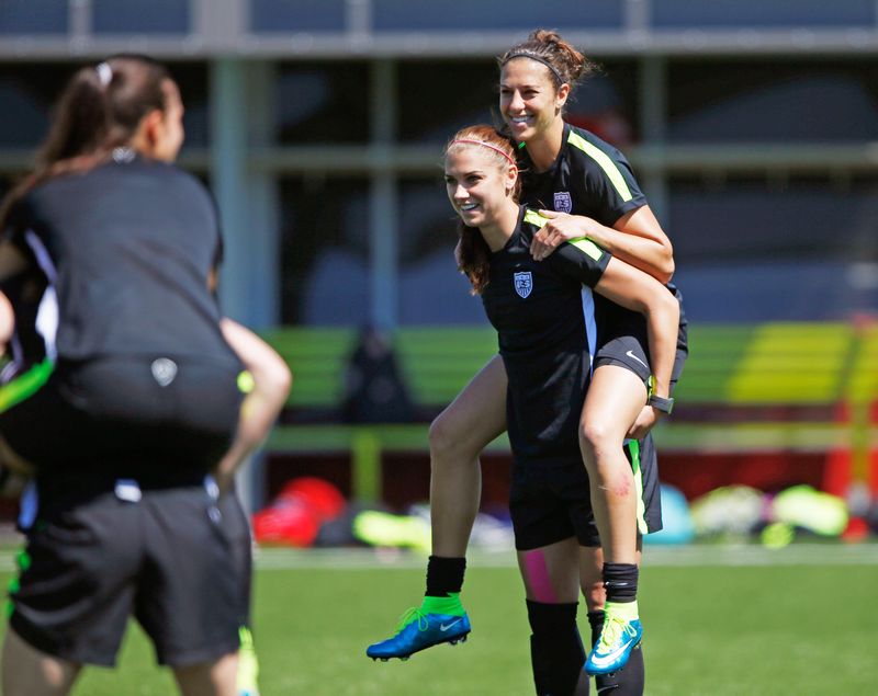 US forward Alex Morgan carries midfielder Carli Lloyd while playing a game during a training session for the 2015 Women's World Cup in Vancouver July 3, 2015. u00e2u20acu201d Reuters pic