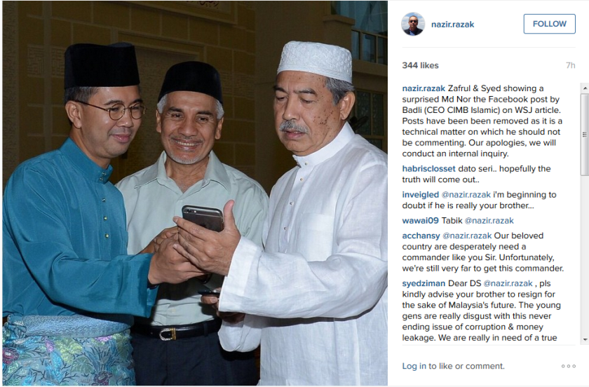 In his caption, Nazir had described his two colleagues as showing a 'surprised' Tan Sri Md Nor Yusof (right) the Facebook posting by Badlisyah on WSJ’s article. — Instagram screencap