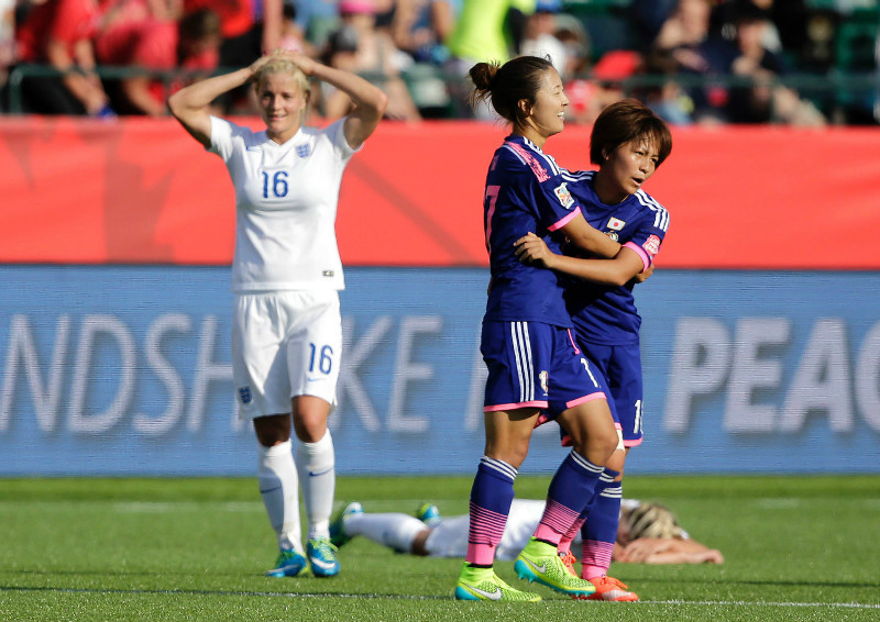 Japanese players celebrate as England midfielder Katie Chapman (16) reacts after an own goal by defender Laura Bassett (on ground) during the second half of the 2015 Women's World Cup semifinals in Edmonton, July 1, 2015. u00e2u20acu201d Erich Schlegel-USA TO