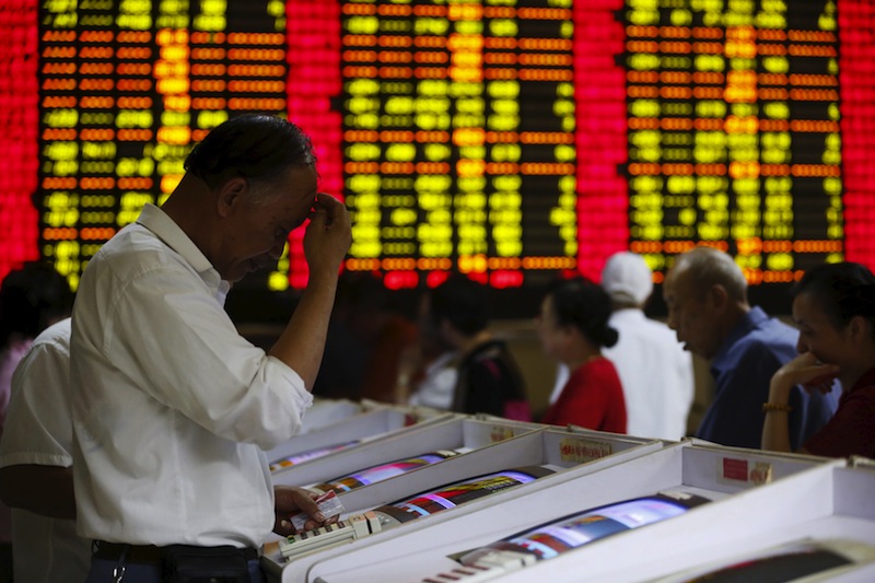 Investors look at computer screens showing stock information at a brokerage house in Shanghai, China, July 8, 2015. u00e2u20acu201d Reuters pic