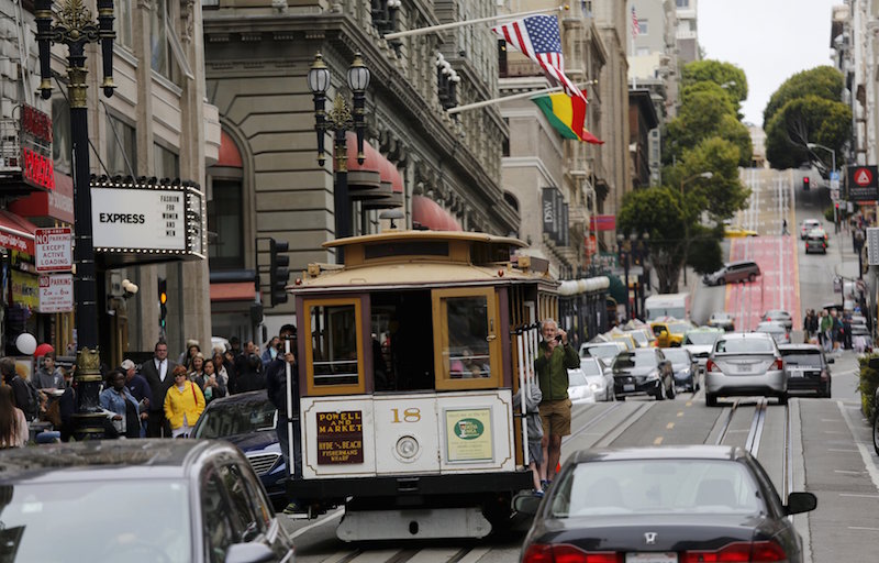 A man takes a photo from a cable car near Union Square in San Francisco, California June 22, 2015. u00e2u20acu201d Reuters pic