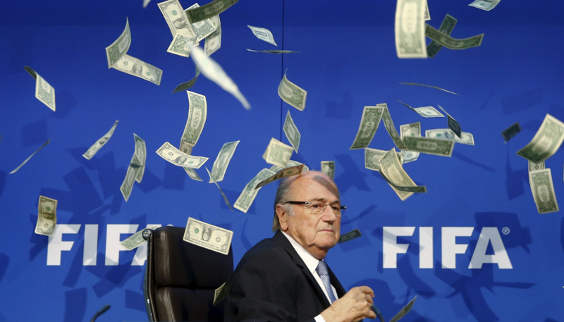 British comedian Lee Nelson (unseen) throws banknotes at FIFA President Sepp Blatter as he arrives for a news conference after the Extraordinary FIFA Executive Committee Meeting at the FIFA headquarters in Zurich, July 20, 2015. u00e2u20acu201d Reuters pic