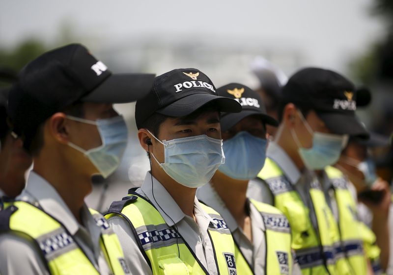 Policemen wearing masks to prevent contracting MERS stand guard in front of Japanese Embassy in Seoul, June 22, 2015. u00e2u20acu201d Reuters pic