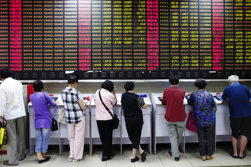 Investors look at computer screens showing stock information at a brokerage house in Shanghai, China, July 8, 2015.u00c2u00a0u00e2u20acu201d Reuters pic