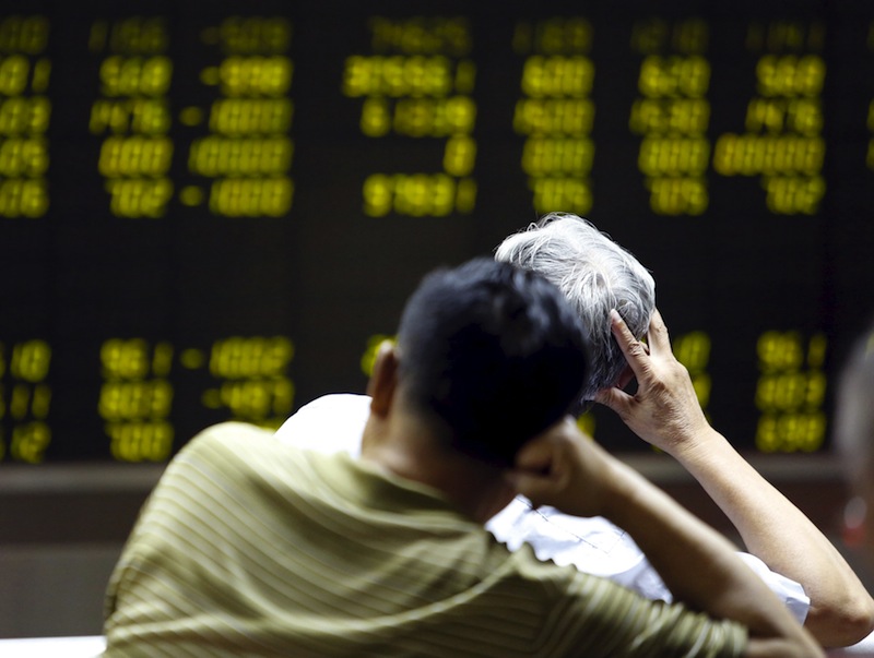 Investors watch an electronic board showing stock information at a brokerage office in Beijing, China, July 7, 2015. u00e2u20acu201d Reuters pic