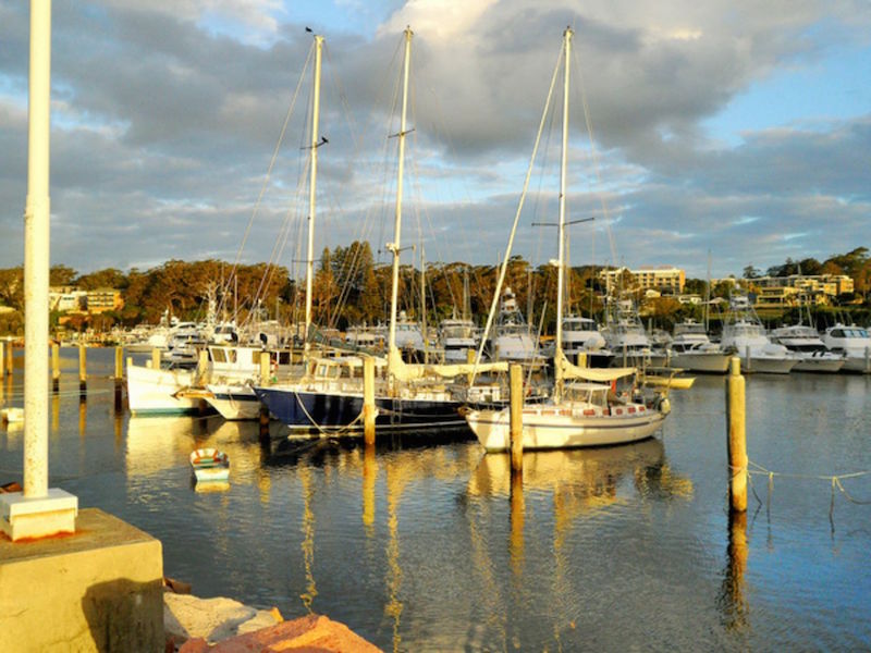 Enjoy the picturesque view of the yachts at sea against the sunset at Port Stephens.