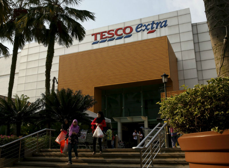 Women leave a Tesco Extra store in Kuala Lumpur, Malaysia, July 6, 2015. Japan's Aeon Co Ltd is interested in buying the Malaysian operations of Tesco PLC, valued at about u00c2u00a3900 million (RM5.3 billion). u00e2u20acu201d Reuters pic