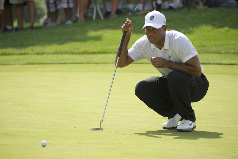 Tiger Woods check his ball before putting in the first round of the Quicken Loans National golf tournament at Robert Trent Jones Golf Club. u00e2u20acu201d Reuters pic