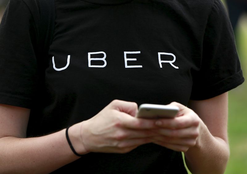 An Uber representative registers people on his smartphone during the citywide jobs tour in the Queens borough of New York July 21, 2015. u00e2u20acu201d Reuters pic
