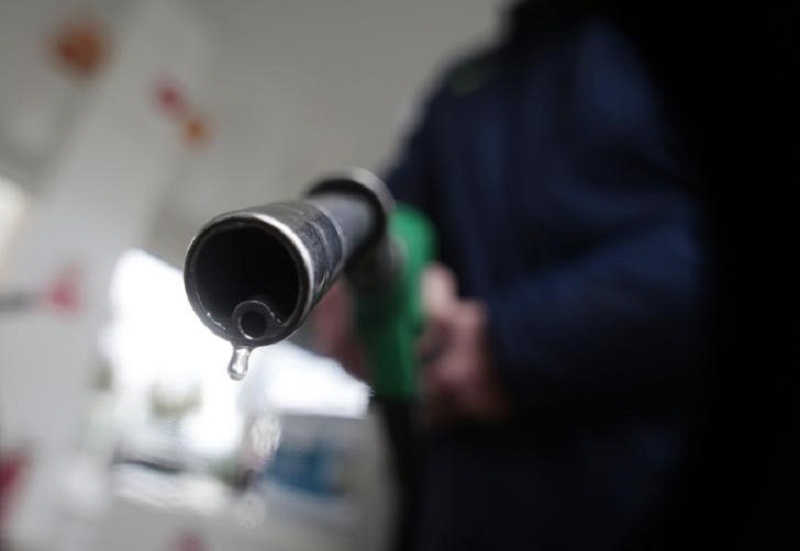 A customer holds a nozzle to fill up his tank in a gasoline station in Nice December 5, 2014. u00e2u20acu201d Reuters pic