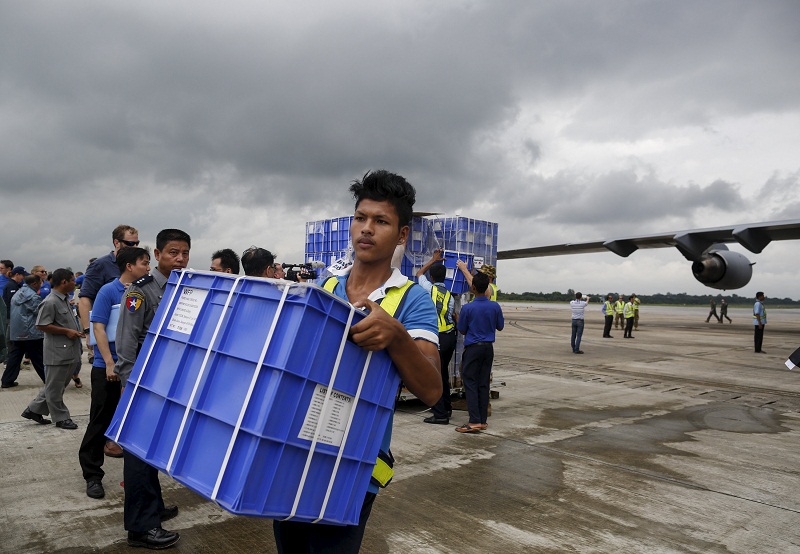 A worker unload aid from a Royal Australian Air Force (RAAF) transport plane carrying donated aid for Myanmaru00e2u20acu2122s flood victims at Yangon international airport in Yangon on August 10, 2015. u00e2u20acu201d Reuters pic