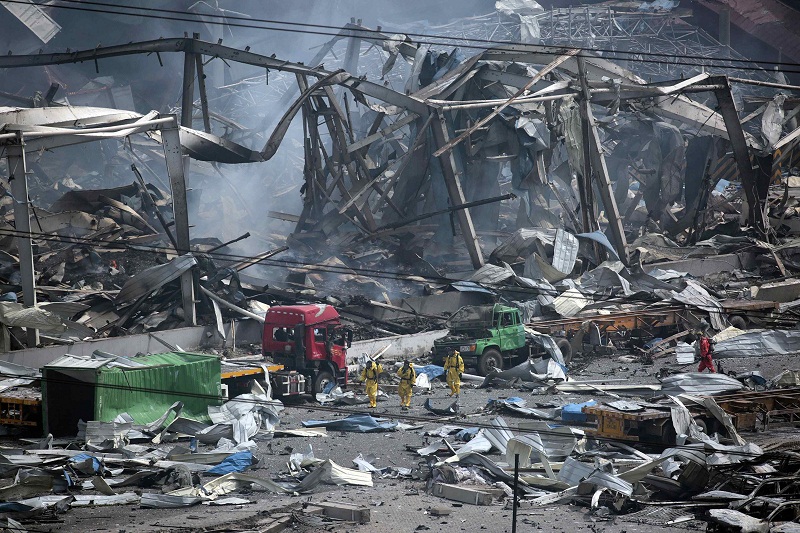 Rescue workers wearing chemical protective suits walk at the site of the explosions at the Binhai new district in Tianjin, China, August 14, 2015. u00e2u20acu201d Reuters pic