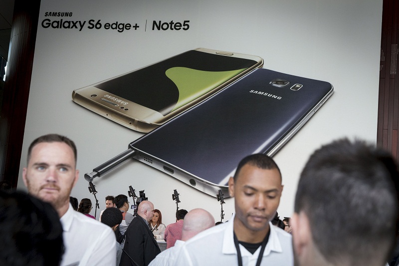 People attend the Samsung Galaxy Unpacked 2015 event beneath images of a Samsung Galaxy S6 Edge+ and a Samsung Galaxy Note 5 in New York. Picture released August 14, 2015. u00e2u20acu201d Reuters pic