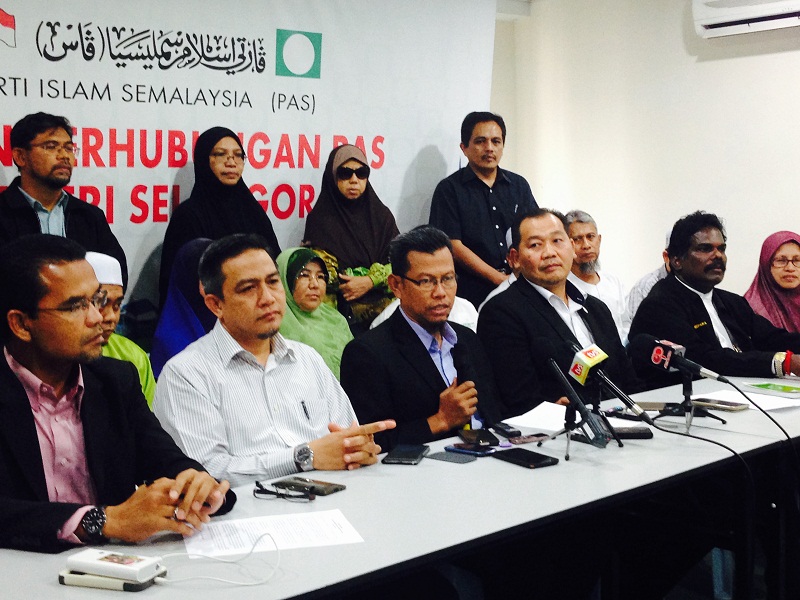 Mohd Khairuddin Othman (seated, fourth from the left) speak to reporters from the partyu00e2u20acu2122s Shah Alam headquarters, along with other leaders and members from Selangor PAS. u00e2u20acu201d Picture by Melissa Chi