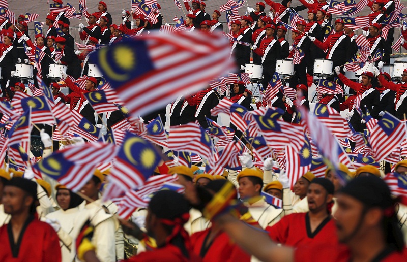 Performers wave the national flag during National Day celebrations in Kuala Lumpur, August 31, 2015. u00e2u20acu201d Reuters pic