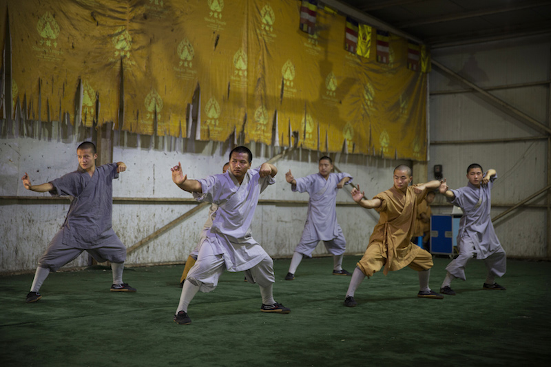 Several monks perform kung fu for tourists at the Shaolin Temple in Dengfeng, China, July 31, 2015. u00e2u20acu201d Picture by Adam Dean/The New York Times