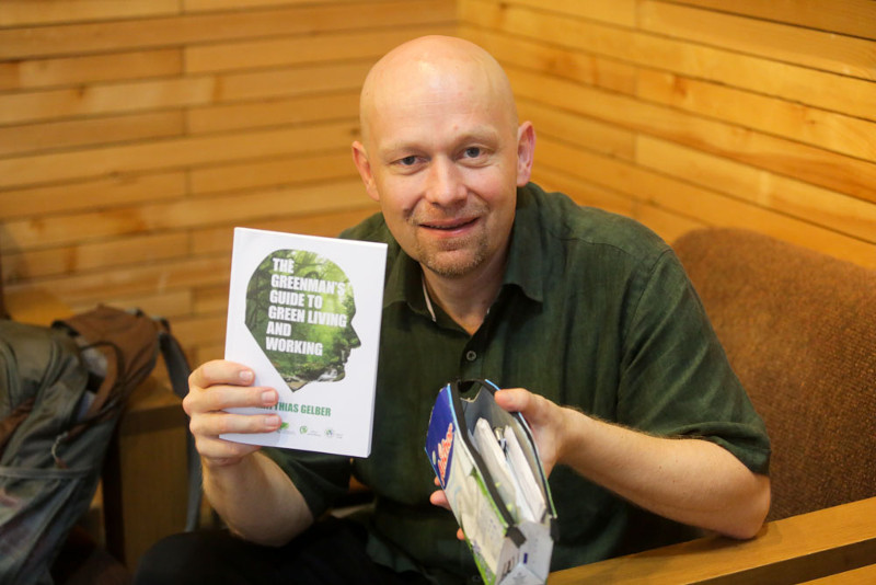 Matthias Gelber poses with his green book and recycled wallet. — Picture by Choo Choy May