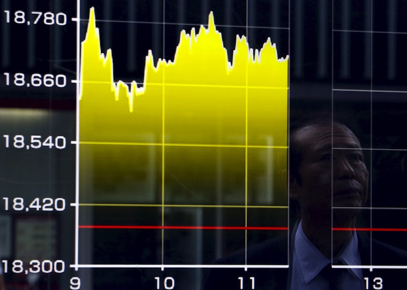 A pedestrian is reflected on an electronic board showing the graph of the recent fluctuations of the Japan's Nikkei average outside a brokerage in Tokyo, Japan, August 27, 2015.u00c2u00a0u00e2u20acu201d Reuters pic