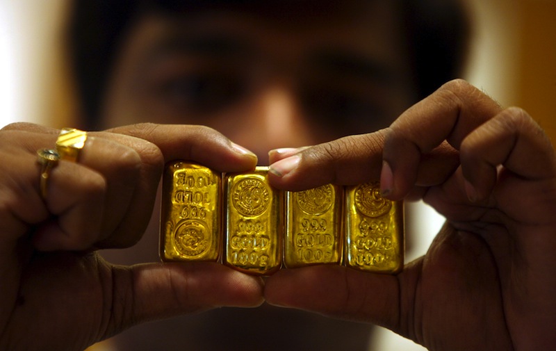 A salesman displays gold bars inside a jewellery shop in the southern Indian city of Hyderabad in this May 6, 2011 file photo. u00e2u20acu201d Reuters pic