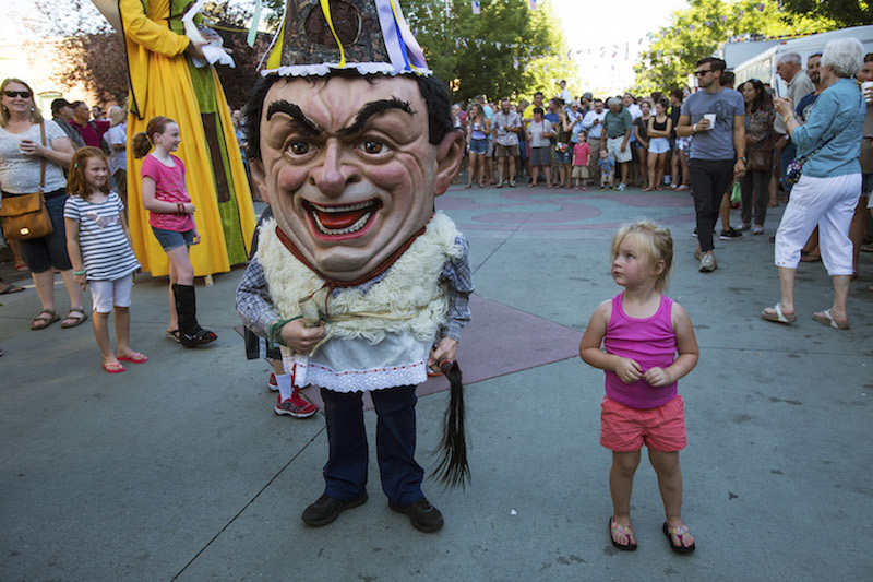 A child looks up at a ‘big head,’ a traditional character that marches and dances through the streets of Boise during the Jaialdi celebration in Idaho, July 30, 2015. — Picture by Ruth Fremson/The New York Times