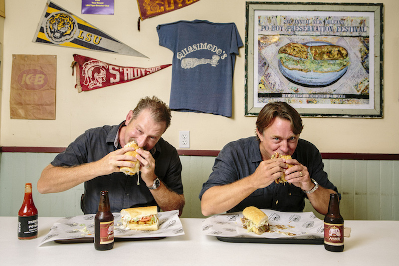 Donald Link, left, and John Besh, two leaders in the New Orleans restaurant renaissance, enjoy po’ boy sandwiches at a city landmark that dates to 1911, the Parkway Bakery & Tavern, July 22, 2015. — Picture by William Widmer/The New York Times