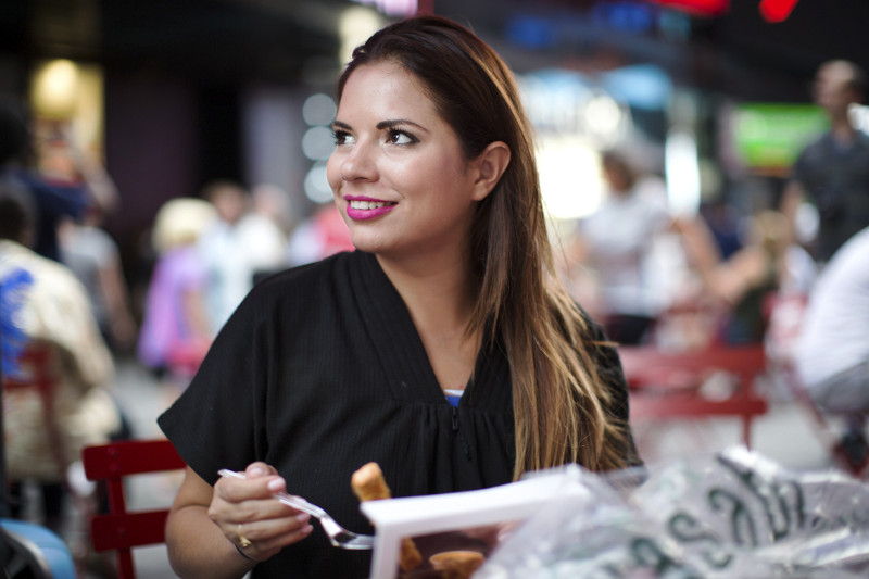 Mey Ovalles eats lunch after posing for photographs with tourists in exchange for tips at Times Square in New York.