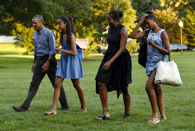 US President Barack Obama (left) walks with First lady Michelle Obama and their daugthers Malia and Sasha on the South Lawn of the White House upon their return to Washington, August 23, 2015. u00e2u20acu201d Reuters pic