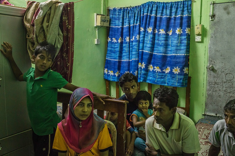 Shahidah Yunus with her husband Dil Muhammad Hussan, second from right, in the house they share with 17 other Rohingya migrants, in Gelugor, Malaysia, May 28, 2015.  — Picture by Mauricio Lima for The New York Times