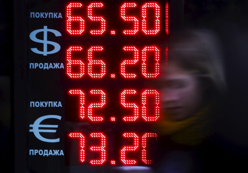 A woman walks past a board, showing currency exchange rates of the US dollar and euro against the rouble, in Moscow, Russia, August 18, 2015.u00c2u00a0u00e2u20acu201d Reuters pic