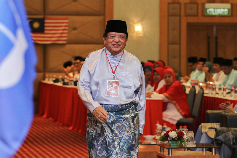 Malaysian Minister of the Federal Territories Datuk Seri Tengku Adnan Tengku Mansor heads to the stage to deliver his keynote address during Umno Putrajaya division delegates' meeting in Putrajaya, August 26, 2015. u00e2u20acu201d Picture by Yusof Mat Isa