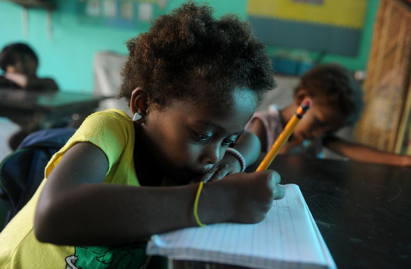 This photo taken June 11, 2015 shows Aeta children write as they attend school in Sapang Uwak. u00e2u20acu201d AFP pic