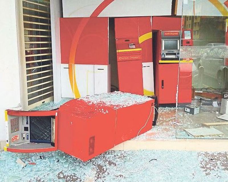 The ATM machine lies on its side after the attempted robbery. u00e2u20acu2022 Malay Mail pic