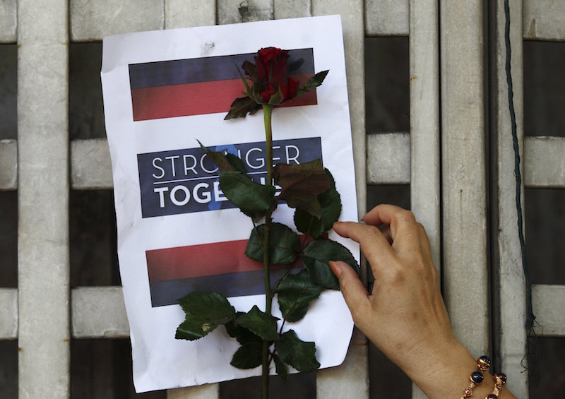 A woman leaves a rose for the victims at the site of a deadly blast in central Bangkok August 18, 2015. u00e2u20acu201d Reuters pic