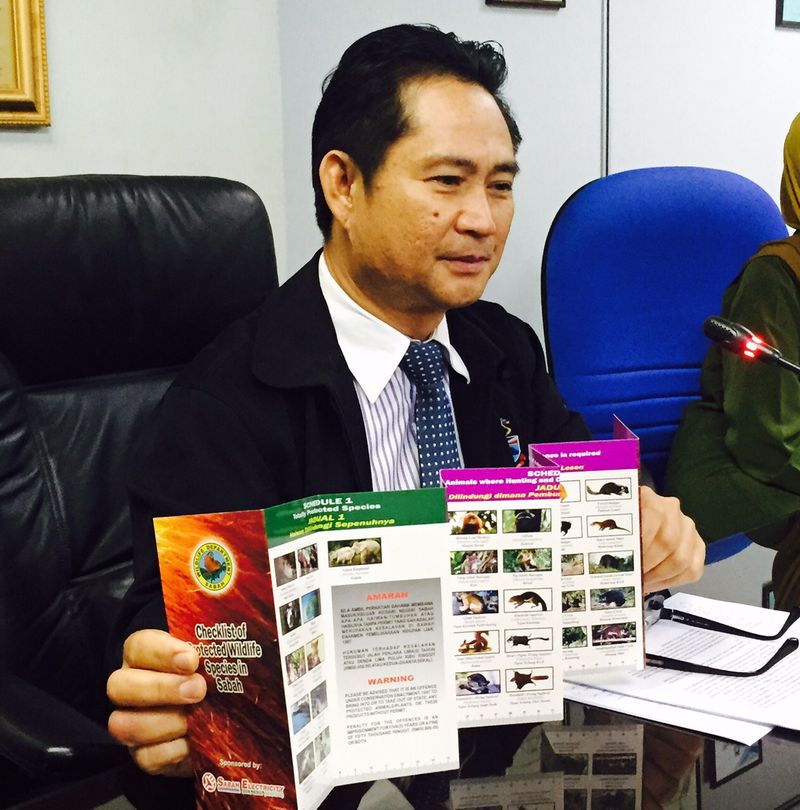 Sabah wildlife department director William Baya with a list of protected species in Sabah. u00e2u20acu201d Picture courtesy of Sabah Wildlife Department
