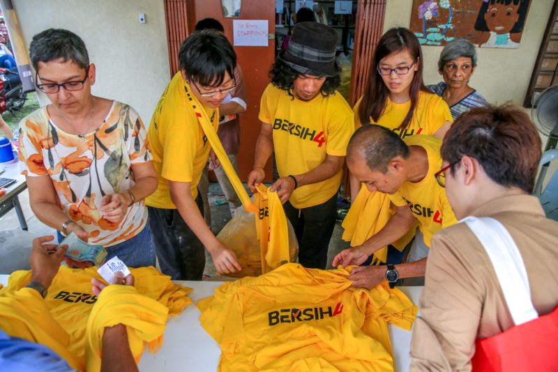 Supporters choosing the popular yellow Bersih 4 T-shirts from the Bersih 2.0 Petaling Jaya office, August 25, 2015. u00e2u20acu201d Picture by Saw Siow Feng 