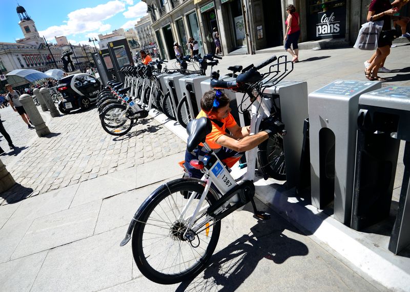 A municipal employee carries out preventative maintenance and repairs on a BiciMad public electric bikes share station in Madrid on August 13, 2015. u00e2u20acu201d AFP pic