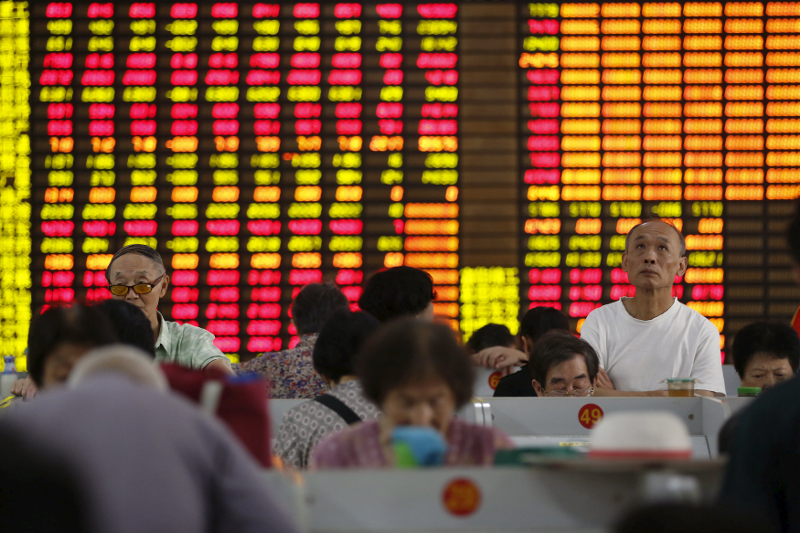 Investors look at computer screens showing stock information at a brokerage in Shanghai, China, August 13, 2015. u00e2u20acu201d Reuters pic