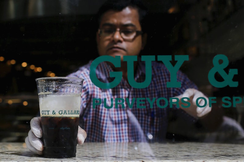A Guy & Gallard cafeteria employee serves a nitrogen-infused cold brew coffee from Brooklyn-based roaster Gillies Coffee out of a tap at its cafeteria in New York July 31, 2015. u00e2u20acu201d Reuters pic